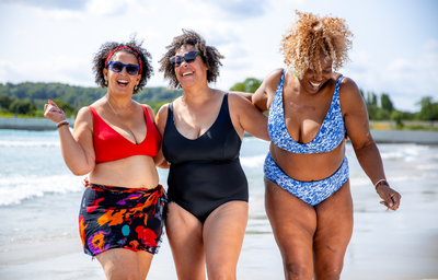 (L-R) Jayne wears Adjustable Plunge Bikini Top Scarlet, size 16 Monroe; Amy wears Reversible Plunge Swimsuit Leopard & Black, size 16 Hendricks; Sima wears Adjustable Plunge High Waist Bikini Set Mountain River, size 18 Hendricks