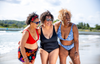 (L-R) Jayne wears Adjustable Plunge Bikini Top Scarlet, size 16 Monroe; Amy wears Reversible Plunge Swimsuit Leopard & Black, size 16 Hendricks; Sima wears Adjustable Plunge High Waist Bikini Set Mountain River, size 18 Hendricks